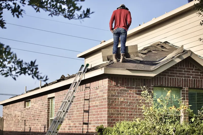 Professional roofer working on a residential roof in Lakeview